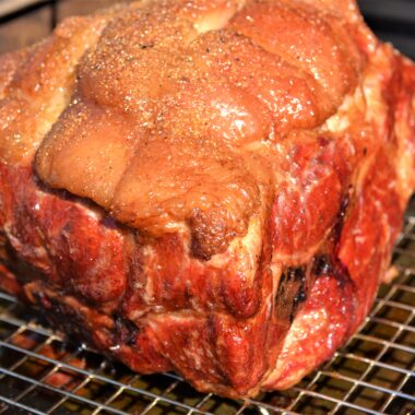 pork butt cooking on grill