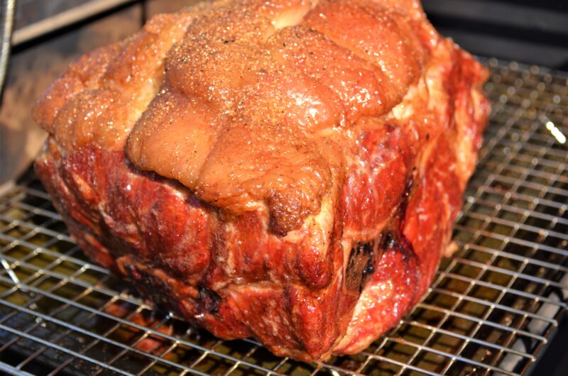 pork butt cooking on grill
